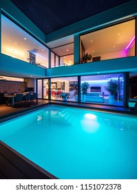 Modern Villa With Colored Led Lights At Night. Nobody Inside