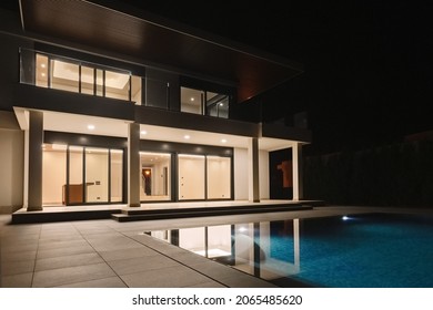 Modern Villa With Pool At Night. Home Real Estate Luxury Exterior With Led Lights. Nobody Inside.