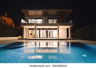 Modern Villa With Pool At Night. Home Real Estate Luxury Exterior With Led Lights. Nobody Inside.