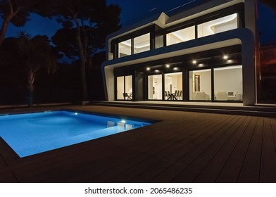 Modern Villa With Pool At Night. Home Real Estate Luxury Exterior With Led Lights. Nobody Inside.