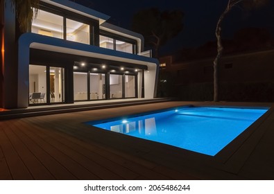 Modern Villa With Pool At Night. Home Real Estate Luxury Exterior With Led Lights. Nobody Inside.