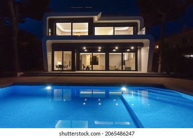 Modern Villa With Pool At Night. Home Real Estate Luxury Exterior With Led Lights. Nobody Inside.