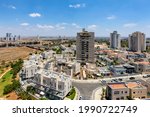 Modern villas, private houses and residential buildings under blue sky in a new neighborhood of Kiryat Gat, Israel.