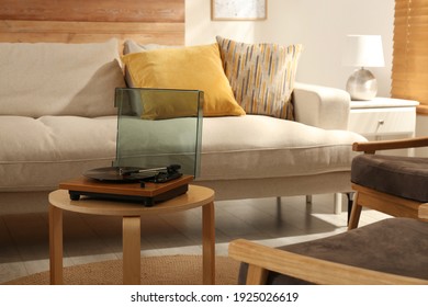 Modern Vinyl Record Player With Disc On Table Indoors