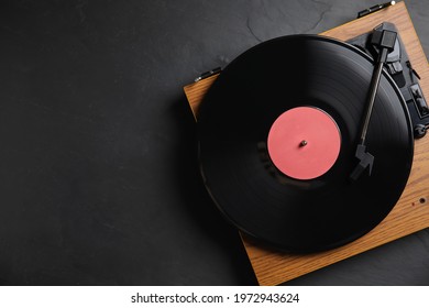 Modern vinyl record player with disc on black background, top view. Space for text - Powered by Shutterstock