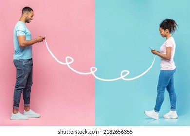 Modern Virtual Communication. Young Black Couple Texting With Each Other, Using Their Smartphones, Walking Over Blue And Pink Studio Background