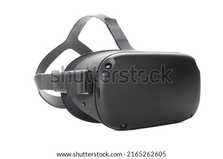 Modern virtual reality glasses isolated on a white background. Side view from the front. VR helmet for gaming, entertainment and learning