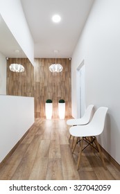 Modern Waiting Room, Reception. Cozy Minimalistic Interior With Seats, Lights, Mirror And Parquet Floor.