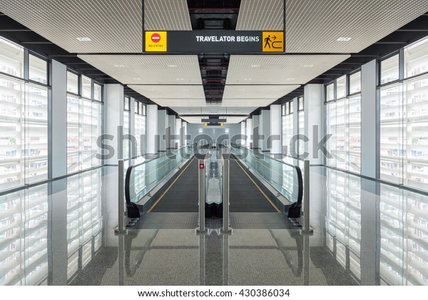Modern walkway of\
escalator move forward and escalator move backward in international\
airport. Escalator is facility for support transportation in modern\
building\

