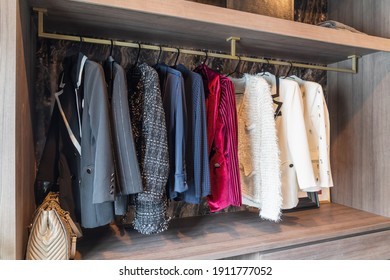 modern wardorbe with set of clothes hanging on rail, modern closet interior design concept