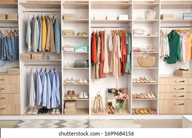 Modern wardrobe with stylish spring clothes and accessories - Shutterstock ID 1699684156