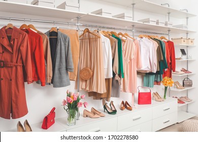 Modern wardrobe with stylish spring clothes and accessories - Shutterstock ID 1702278580