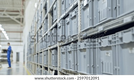 A modern warehouse facility featuring gray storage bins and efficient workers in action