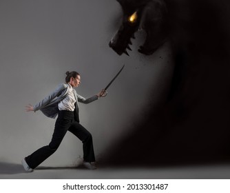 Modern warrior, struggle with external conflicts or internal self-doubt, concept photo art. A young woman in a suit and with a saber fights with a shadow in the form of a beast