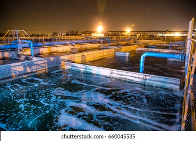 Modern Wastewater Treatment Plant Of Chemical Factory At Night. Water Purification Tanks