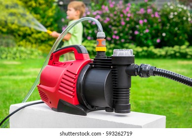 Modern Water Pump In The Garden On A Hot Summer Day