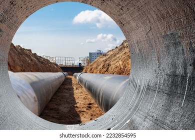 Modern water supply and sewerage system. Underground pipeline works. Water supply and wastewater disposal of a residential city. Close-up of underground utilities. View from the big pipe - Shutterstock ID 2232854595