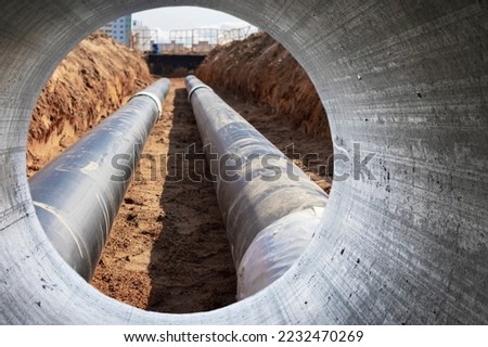 Modern water supply and sewerage system. Underground pipeline works. Water supply and wastewater disposal of a residential city. Close-up of underground utilities. View from the big pipe