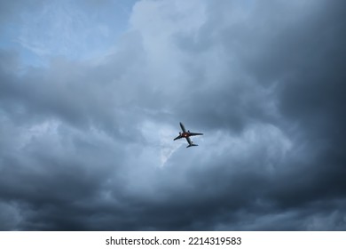 Modern white airplane flying in sky with clouds, low angle view - Powered by Shutterstock