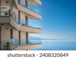 Modern white apartment building with blue sky and sea background. Beautiful modern architecture of the building. Architecture detail Modern facade building with balconies and windows