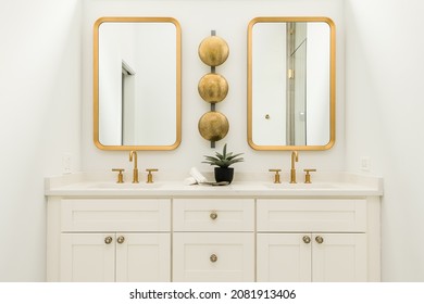 Modern White Bathroom with Gold Fixtures and Accents