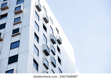 Modern white building with square windows. Multistory apartment building. Minimalistic Stylish living block of flats. Facades of modern office building. Exterior texture pattern