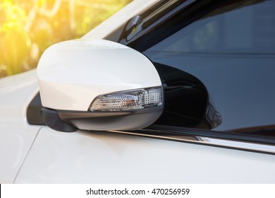 modern white car side view mirror folded with turn signal