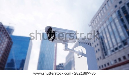 Modern White CCTV Security Camera Pointing Directly at the buiding city.