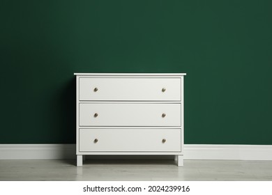 Modern White Chest Of Drawers Near Green Wall Indoors