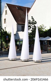 Modern White Conical Lights Displayed in Outdoor German Town Square 