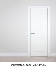 Modern White Door. Grey Wall With Free Space. Minimalist Bright Interior