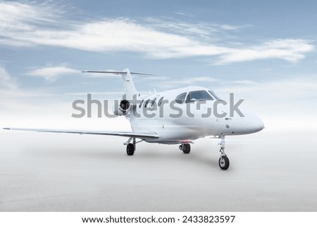Modern white executive jet plane isolated on bright background with sky