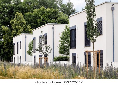 Modern White Facade of Residential Houses Multifamily Buildings with Green Area and Panoramic Windows Blinds. New Real Estate Apartment Building for Rent or Living. - Shutterstock ID 2337725439