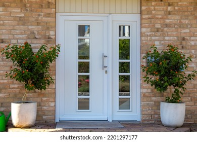 Modern White Front Door On A New Residential House With A Beautiful Clinker Facade