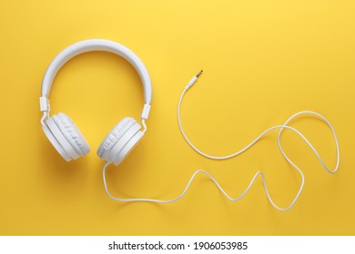 Modern white headphone on yellow background. Music concept. - Shutterstock ID 1906053985