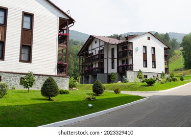 Modern white houses with green lawns nearby. Hotels in Manzherok, Altai. - Powered by Shutterstock