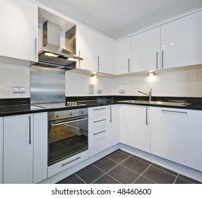 Modern White Kitchen With Black Granite Worktop