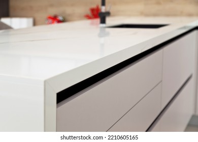 Modern white lacquer and ash tree wood kitchen cabinet equipment and black faucet on white granite countertop