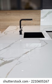 Modern White Lacquer And Ash Tree Wood Kitchen Cabinet Equipment And Black Faucet On White Granite Countertop