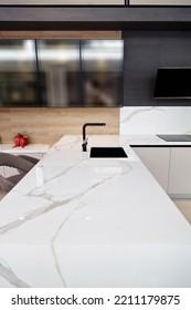 Modern White Lacquer And Ash Tree Wood Kitchen Cabinet Equipment And Black Faucet On White Granite Countertop