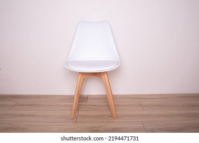 Modern White Leather Chair On Wooden Background