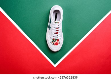 Modern white leather sneaker for women with a toe cap and bright tropical print insert isolated on a contrasting multicolor background with copy space. Fashion blogger content. Summer season footwear. - Powered by Shutterstock