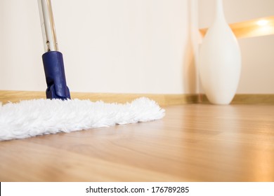 Modern White Mop Cleaning Wooden Floor From Dust