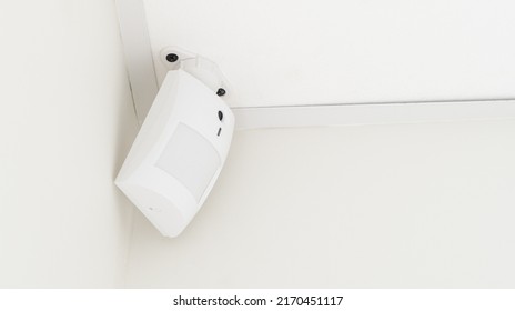 Modern white motion sensor on the wall in the room. - Shutterstock ID 2170451117