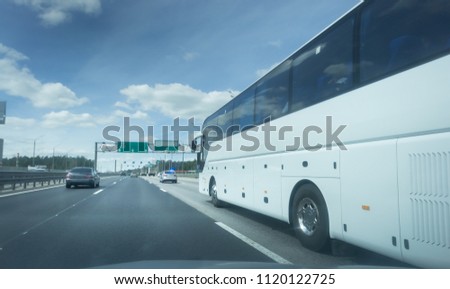 Modern White Passenger Bus on the highway, City Tourist Bus Transportation Vehicle, Modern and Comfortable Coach, Traveling by Bus