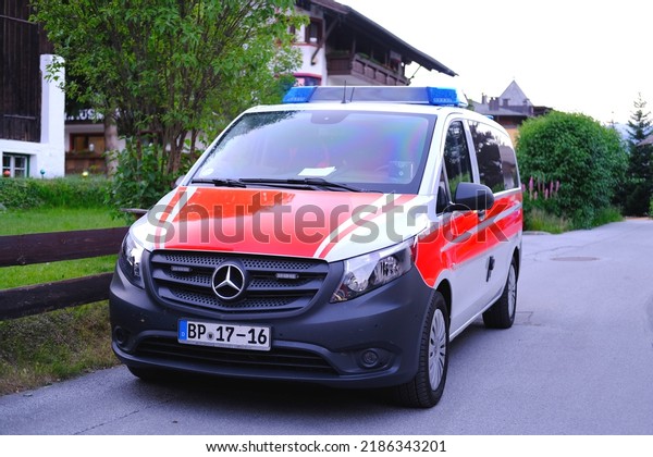 modern white, Red ambulance emergency service\
vehicle, medics provide assistance, concept of emergency medical\
care, patient transportation in car to hospital, helping, Seefeld,\
Austria - June 2022