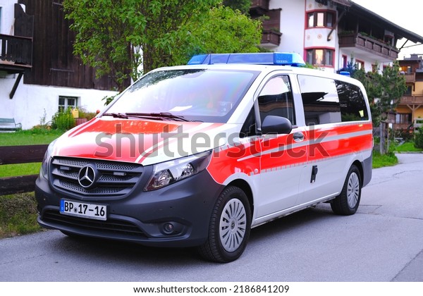 modern white, Red ambulance emergency service\
vehicle, medics provide assistance, concept of emergency medical\
care, patient transportation in car to hospital, helping, Seefeld,\
Austria - June 2022