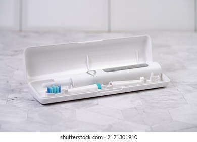 Modern White Sonic Or Electric Toothbrush In Travel Case. Concept Of Professional Oral Care And Healthy Teeth By Using Sonic Smart Toothbrush. Minimal Design