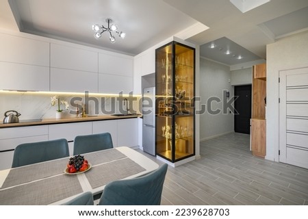 A modern white studio with a kitchen that is fully equipped and ready to use