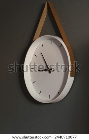 Modern White wall clock isolated on Grey background. Enhance your interior with this stylish timepiece.